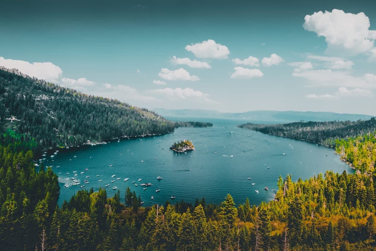 Forested lake with boats representing Lake Norman